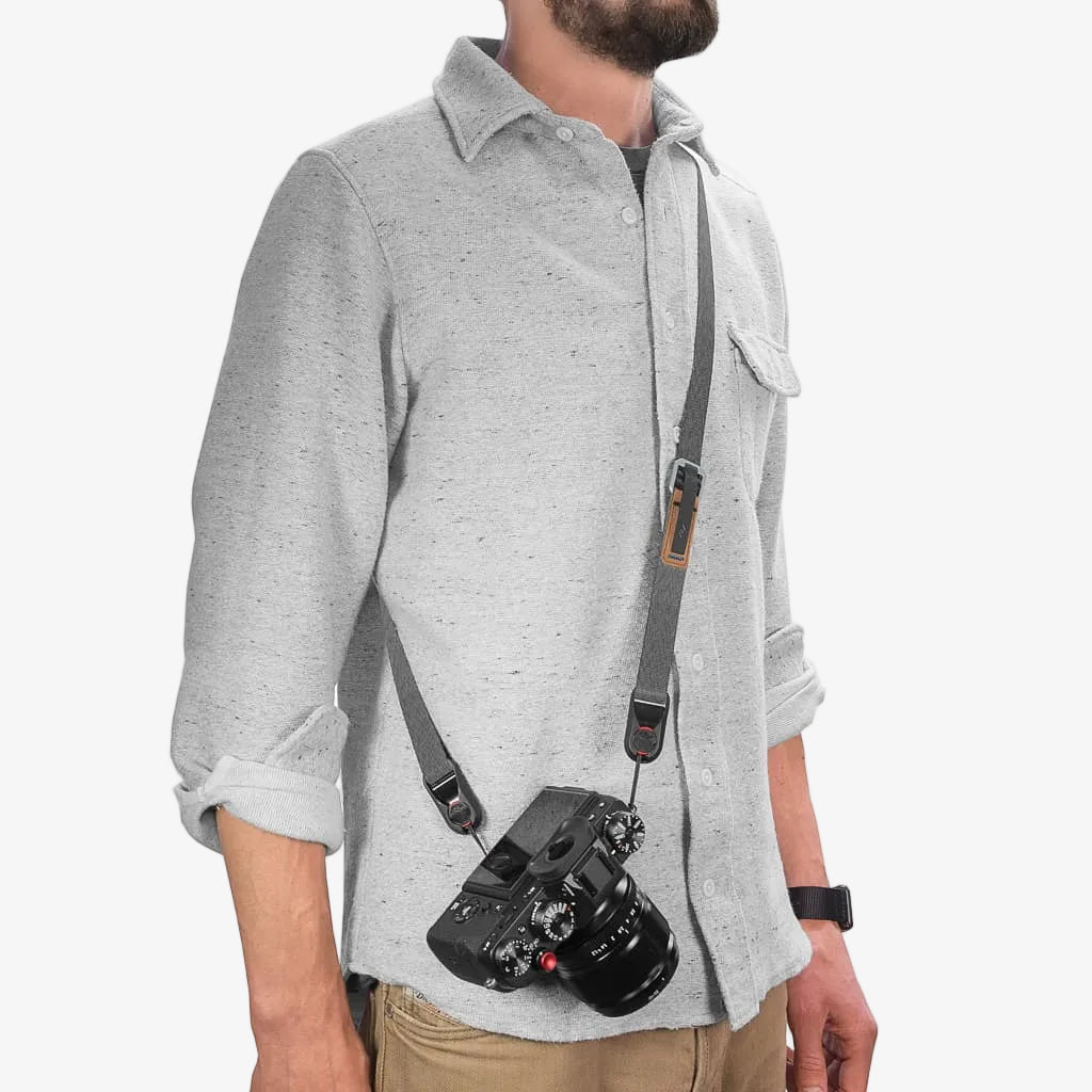 person wearing black peak design leash strap