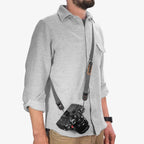 person wearing black peak design leash strap