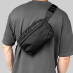 Person wearing a black Toshi 2.5-liter sling bag