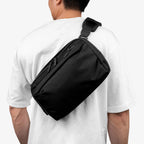 Black Toshi 6-liter shoulder bag worn a person
